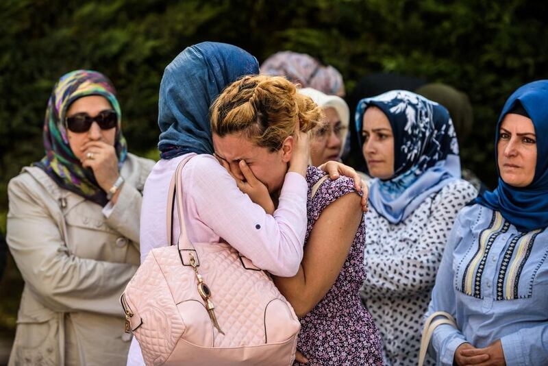 Relatives of a victim of the Ataturk airport attack mourn in Istanbul during his funeral. Ozan Kose / AFP

