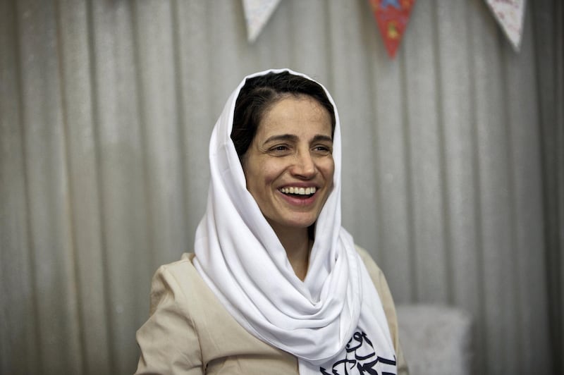 Iranian lawyer Nasrin Sotoudeh smiles at her home in Tehran on September 18, 2013, after being freed following three years in prison. Sotoudeh told AFP she was in "good" physical and psychological condition, and pledged to continue her human rights work. Her release came a week before Iran’s new moderate President Hassan Rowhani, who has promised more freedoms at home and constructive engagement with the world, travels to New York to attend the United Nations General Assembly.  AFP PHOTO/BEHROUZ MEHRI (Photo by BEHROUZ MEHRI / AFP)