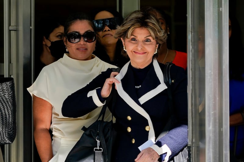 Ms Allred walks out of federal court alongside another Kelly victim, Lizzette Martinez. AP