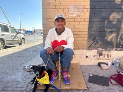 Colombian Camilo Hernandez, 23, with his dog Milon, sits near the Sacred Heart Church in El Paso, Texas. Jihan Abdalla / The National