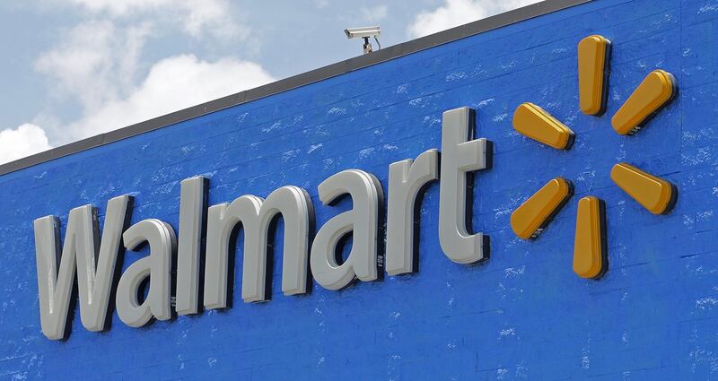 FILE - This Thursday, June 1, 2017, file photo, shows a Walmart sign at one of their stores. A 20-year-old man in southern Oregon filed a lawsuit, Monday, March 5, 2018, against Dickâ€™s Sporting Goods and Walmart after he says they refused to sell him a rifle. (AP Photo/Alan Diaz, File)