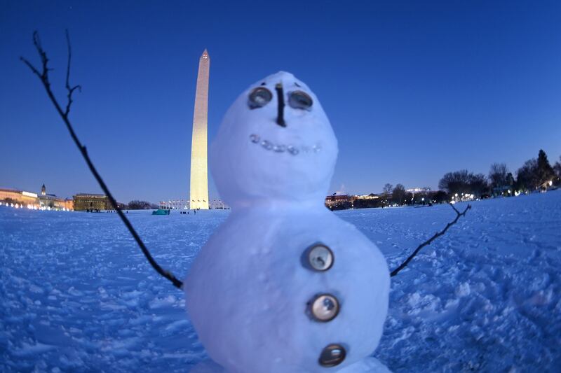 A snowman sits in front of the Washington Monument. AFP