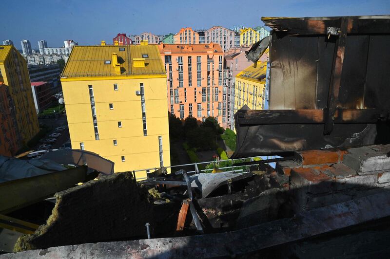 A view of Kyiv through the hole in a roof of a multi-store building damaged as a result of falling debris after a massive drone attack overnight in Kyiv. AFP 
