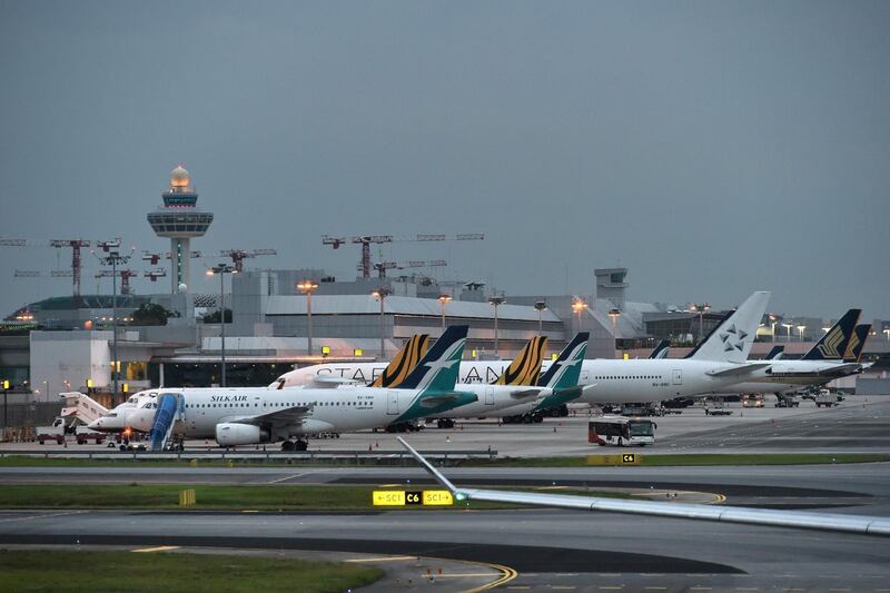 (FILES) In this file photo taken on October 31, 2017 various commercial aircraft are seen parked on the tarmac at the Changi International airport in Singapore. Singapore's aviation regulator on March 12, banned the use of Boeing 737 MAX aircraft in the country's airspace following a deadly Ethiopia plane crash at the weekend. / AFP / Roslan RAHMAN
