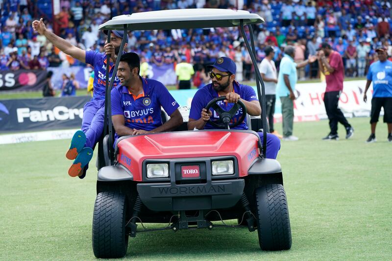 India's Dinesh Karthik, left, Ravichandran Ashwin, centre, and Rohit Sharma ride in a cart after the fifth T20. AP