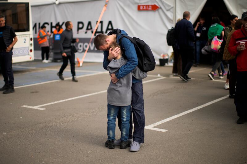 Andrii Fedorov hugs his son Makar as they are reunited in Zaporizhzhia, Ukraine, after the boy and his mother fled besieged Mariupol. AP
