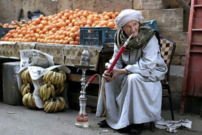 An Egyptian fruit vendor waits for customers in Cairo. Muhammed Muheisen / AP Photo