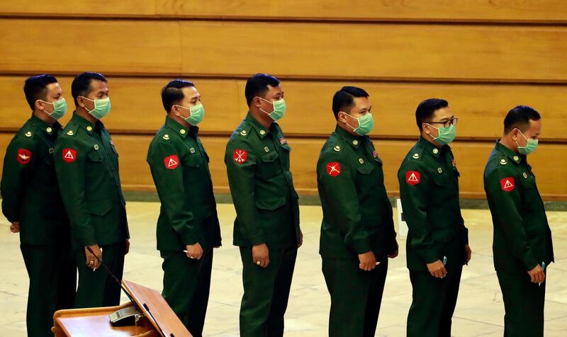 Military representatives line up to cast vote to amend the 2008 Constitution at Union parliament Tuesday, March. 10, 2020, in Naypyitaw, Myanmar. Parliament members began Tuesday cast vote to amend the country's rigid Constitution, including a section that bars Myanmar leader Aung San Suu Kyi to become president, at parliament session. The voting process will take up to 9 parliament days. (AP Photo/Aung Shine Oo)