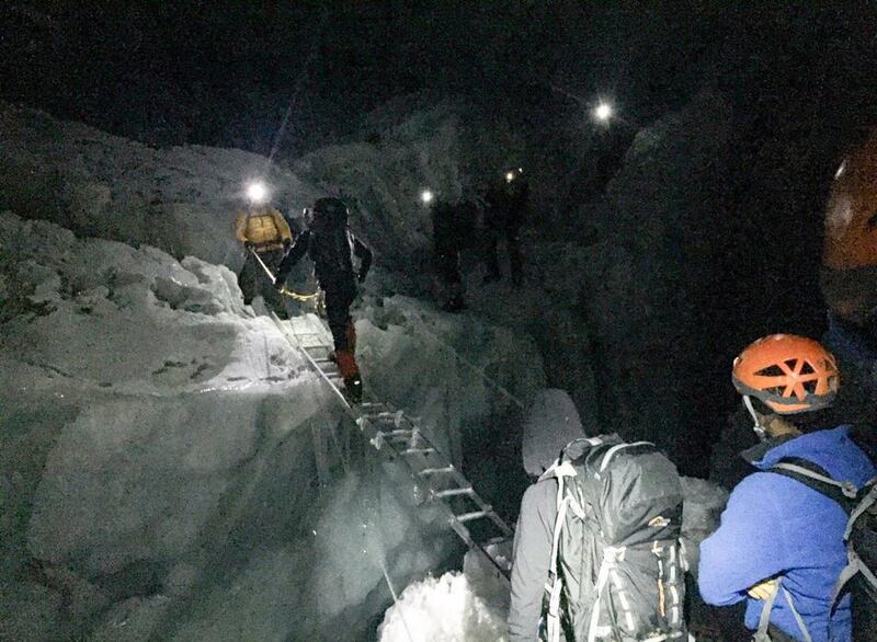 Members of the Armed Forces cross a crevasse in the Khumbu Icefall.