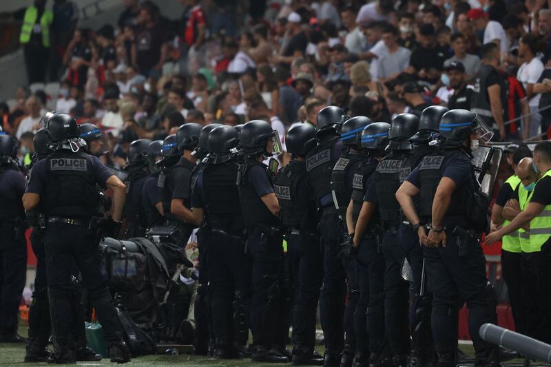 French police stand looking towards the fans. AFP