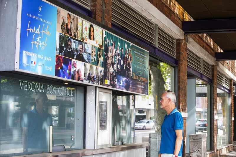 A man is seen reading a temporary closure sign on the box office window of the Palace Verona Cinema, Paddington in Sydney. Getty Images