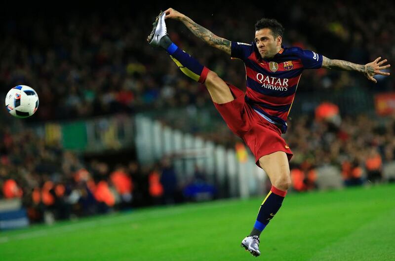 Barcelona’s Brazilian defender Dani Alves jumps for the ball during the Spanish Copa del Rey (King’s Cup) round of 16 first leg football match FC Barcelona vs RCD Espanyol at the Camp Nou stadium in Barcelona on January 6, 2016.   AFP PHOTO/ PAU BARRENA / AFP / PAU BARRENA