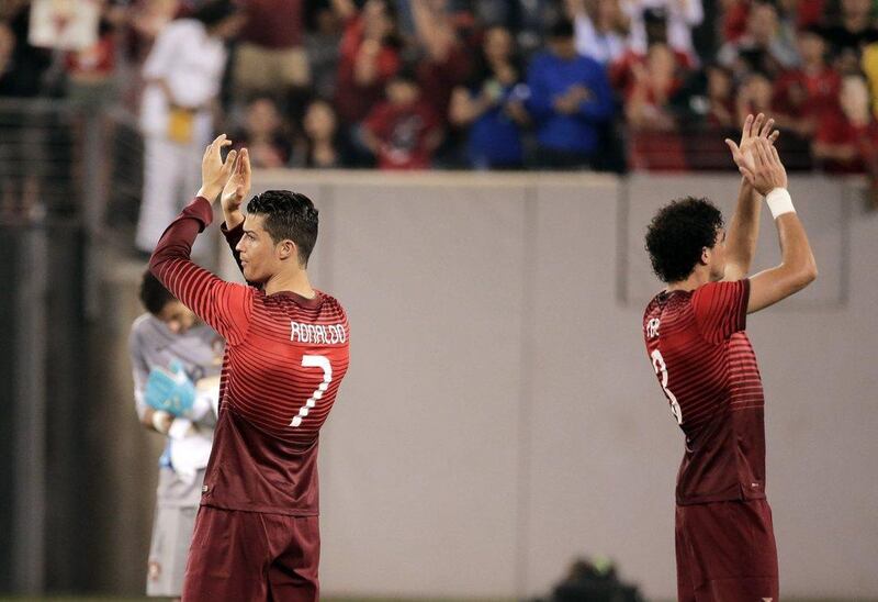 Portugal's Cristiano Ronaldo and Pepe applaud the crowd after beating Ireland 5-1 on Tuesday night as they get in their final preparation before heading to Brazil for the 2014 World Cup. Ray Stubblebine / Reuters / June 10, 2014