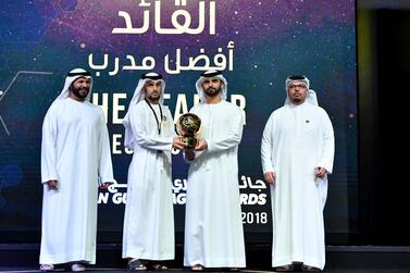 Abdulaziz Al Anbari, centre, picked up the Best coach of the year at the annual Arabian Gulf League Awards at a ceremony in Dubai on Friday. Courtesy AGL