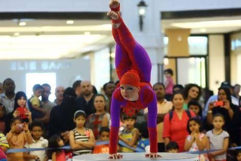 An acrobat from Xtreme Festival international circus performing yesterday at Mall of the Emirates in Dubai, as part of the celebrations during the Dubai Summer Surprises shopping festival. Satish Kumar / The National