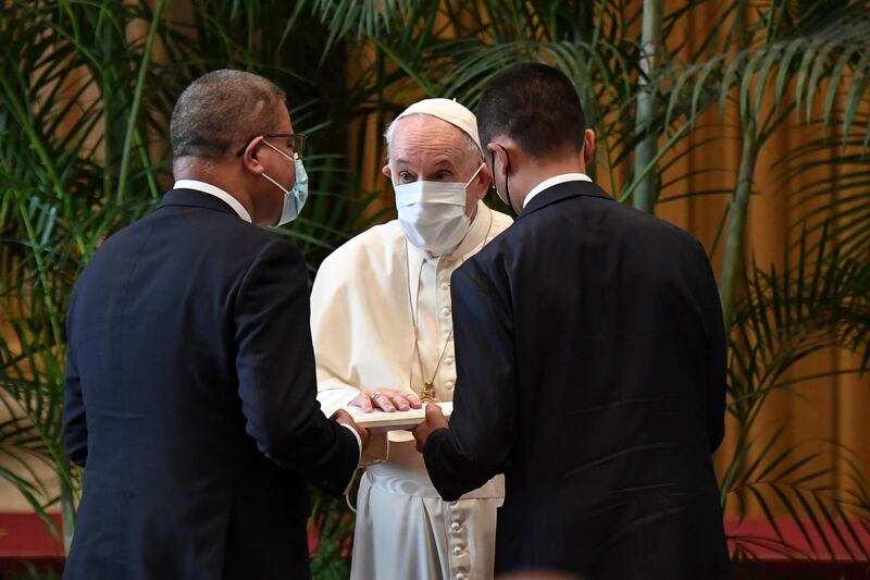 From left, the president of the Cop26 conference, Alok Sharma, Pope Francis and Italian Foreign Minister Luigi Di Maio attend a conference at the Vatican on Monday. AP