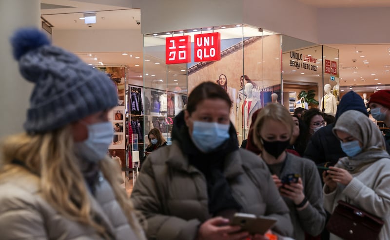 Customers queue to enter Uniqlo in Moscow. In early March, the Japanese fashion brand said it would stop selling clothes in Russia, having earlier defended its decision to keep its stores in the country open. Reuters