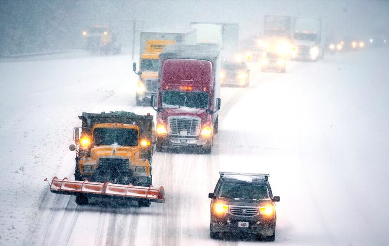 Lorries and cars drive on the snow-covered I-85 in Lexington, North Carolina. AP