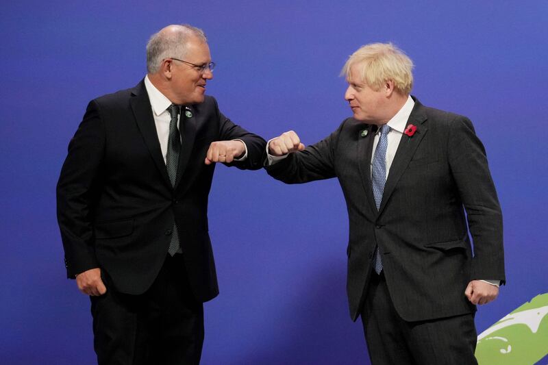 Britain's Prime Minister Boris Johnson greets Australia's Prime Minister Scott Morrison as they arrive to attend the Cop26 UN Climate Change Conference in Glasgow, Scotland, on November 1, 2021. AFP
