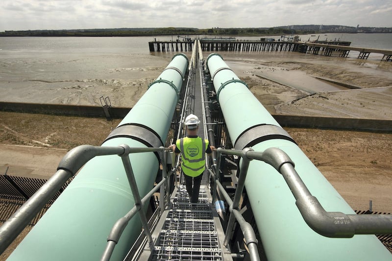 LONDON - JUNE 17:  A worker walks between giant transfer pipes at Britain's first-ever mainland de-salination plant, which is known as the Thames Gateway Water Treatment Works on June 17, 2010 in Beckton, England.  Situated east of London, the Â£270m plant will, when required, turn a mixture of seawater and river water from the tidal River Thames into drinking water for Londoners. This is the world's first four-stage reverse osmosis water treatment works and it is able to produce 150 million litres of water per day - enough to supply 400,000 homes or one million people when fully operational.  (Photo by Peter Macdiarmid/Getty Images)