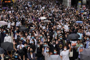 Protesters hold up their hands to represent their five demands as protests continue in Central, Hong Kong, on Tuesday, November 12, 2019. AP