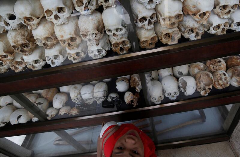A woman looks at skulls and bones at the Choeung Ek memorial during the annual 'Day of Anger', where people gather to remember those who perished during the communist Khmer Rouge regime, on the outskirts of Phnom Penh, Cambodia. Samrang Pring / Reuters