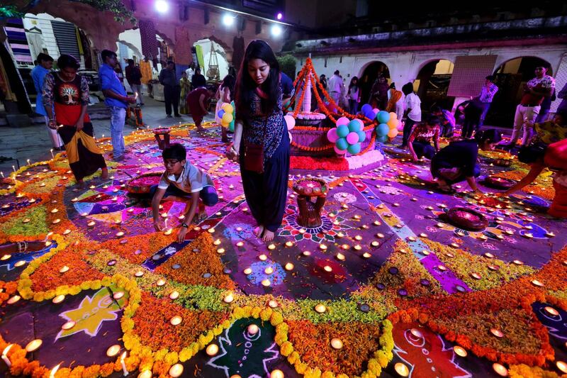 People light oil lamps during the Deep Utsav, or Light Festival, at the historical Gauhar Mahal palace, as part of the Diwali festival celebrations in Bhopal, India on October 18, 2019. The Diwali festival of lights symbolizes the victory of good over evil, commemorating Lord Ram's return to his kingdom Ayodhya after completing a 14-year exile. EPA