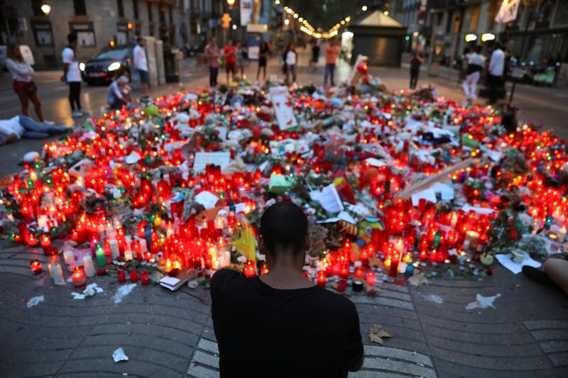 People gather at an impromptu memorial where a van crashed into pedestrians at Las Ramblas, in Barcelona, Spain, August 20, 2017. REUTERS/Susana Vera