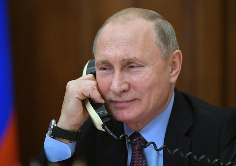 Russian President Vladimir Putin speaks on the phone in his office in the Kremlin in Moscow on December 25.  / AFP / Sputnik / Alexei Druzhinin
