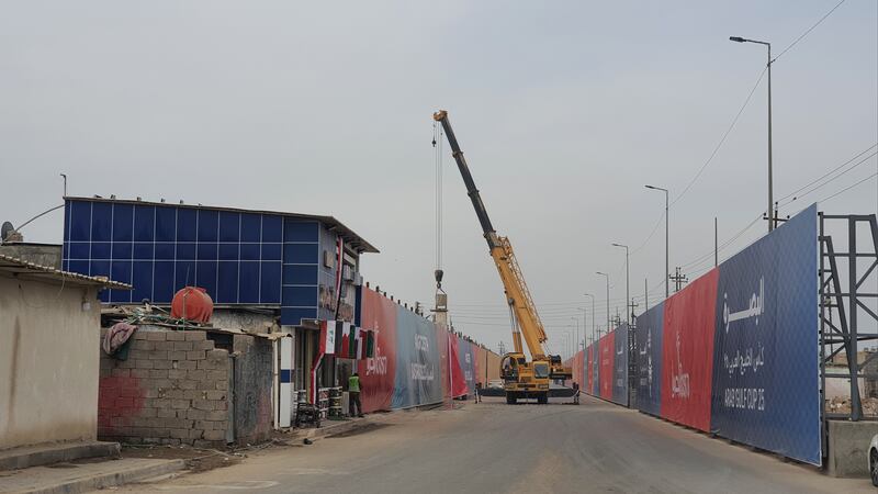 Metal and wooden panels are put up around the city before the start of the tournament