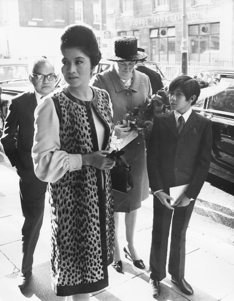 Imelda Marcos, wife of the president of the Philippines, with her son Ferdinand Jr, arriving at Claridge's Hotel, London, in 1970. Getty Images