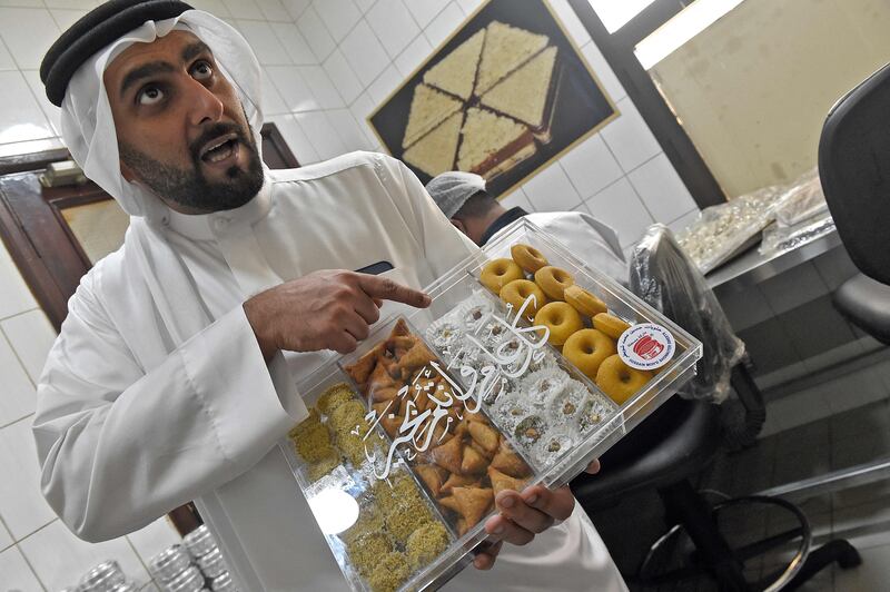 Muhana Fouad Hussain Showaiter, general manager at Hussain Showaiter Sweets and fifth generation member of the family-run business, shows special packaging introduced for Ramadan during a factory tour on Muharraq island.