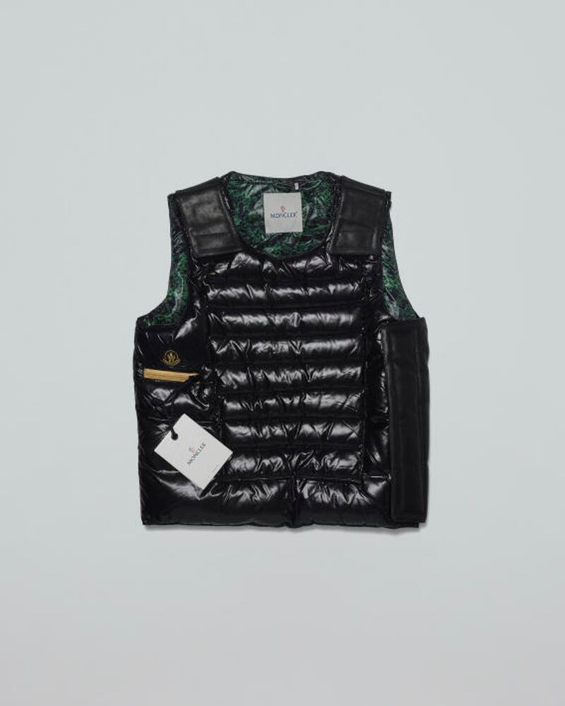 A 2010 Moncler puffer vest designed by Williams. Created to look like a bullet proof vest, the inside is lined in a wood patterning by Japanese artist Keita Sugiura. The vest is made from recycled plastic, and a fibre called Bionic Yarn. Valued at $2,200