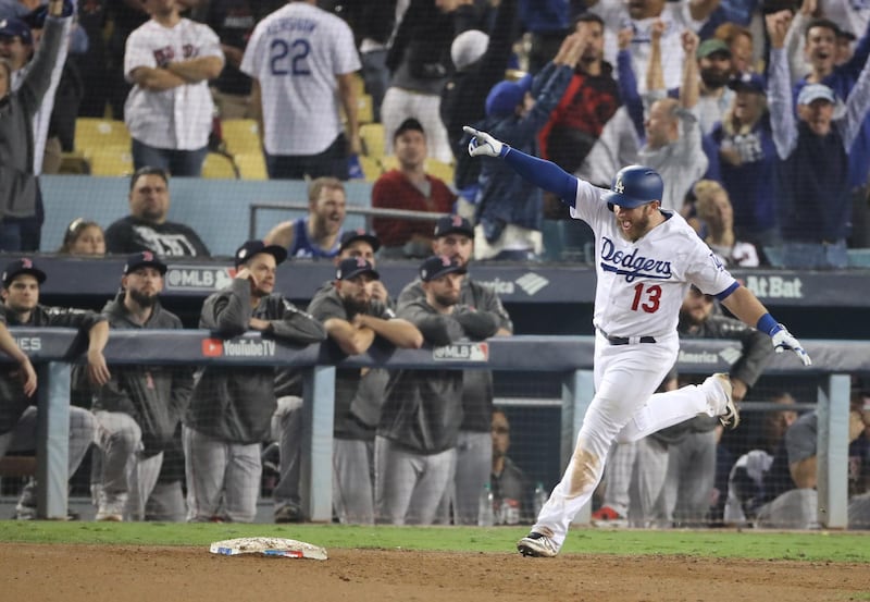 epa07123224 Los Angeles Dodgers batter Max Muncy celebrates after hitting a game-winning walk off home run against the Boston Red Sox in the bottom of the eighteenth inning of game three of the World Series at Dodger Stadium in Los Angeles, California, USA, 26 October 2018. The Red Sox lead the best-of-seven series 2-1 to determine the champion of Major League Baseball.  EPA/ADAM DAVIS