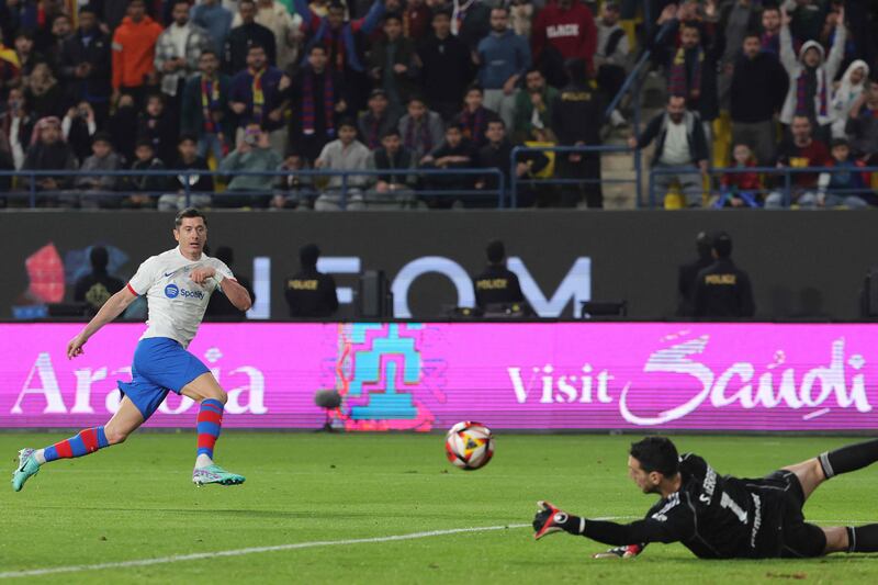 Osasuna goalkeeper Sergio Herrera parries a shot by Barcelona's Robert Lewandowski. AFP