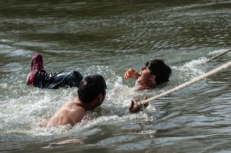 Refugees and migrants are rescued by rope from an island in the middle of Evros river after becoming stucked for the past two days after trying to cross from Turkey to Greece in Edirne, Turkey. Getty Images
