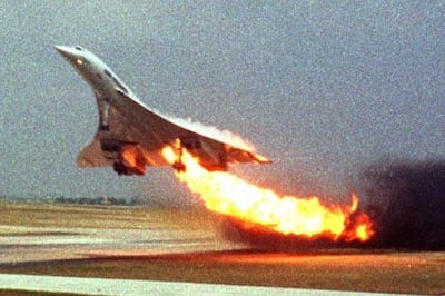 FILE - Air France Concorde flight 4590 takes off with fire trailing from its engine on the left wing from Charles de Gaulle airport in Paris, in this July 25, 2000 file photo.  The plane crashed shortly after take-off, killing all the 109 people aboard and four others on the ground. A decade after a supersonic Concorde jet crashed in a fiery wreck outside Paris soon after takeoff, killing 113 people, a French court will rule at last Monday Dec 6 2010 on who, if anyone, is to blame. (AP Photo/Toshihiko Sato, File) MANDATORY CREDIT PHOTOGRAPHER TOSHIHIKO SATO  JAPAN OUT 