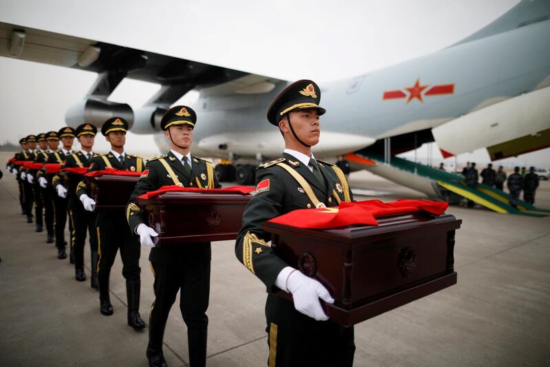 Chinese soldiers carry caskets containing the remains of Chinese soldiers during the handing over ceremony at Incheon International Airport in South Korea. Kim Hong-Ji / Reuters