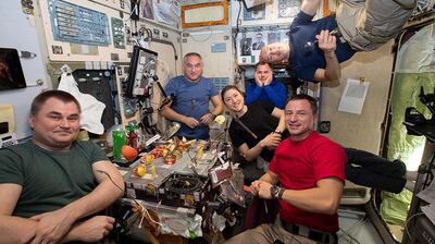 The current six-member Expedition 60 crew gather for dinner inside the galley of the Zvezda service module. When Al Mansouri, Meir and Skripochka arrive there will be nine on the station for eight days. The station's maximum capacity is 12 astronauts. Courtesy: Nasa 