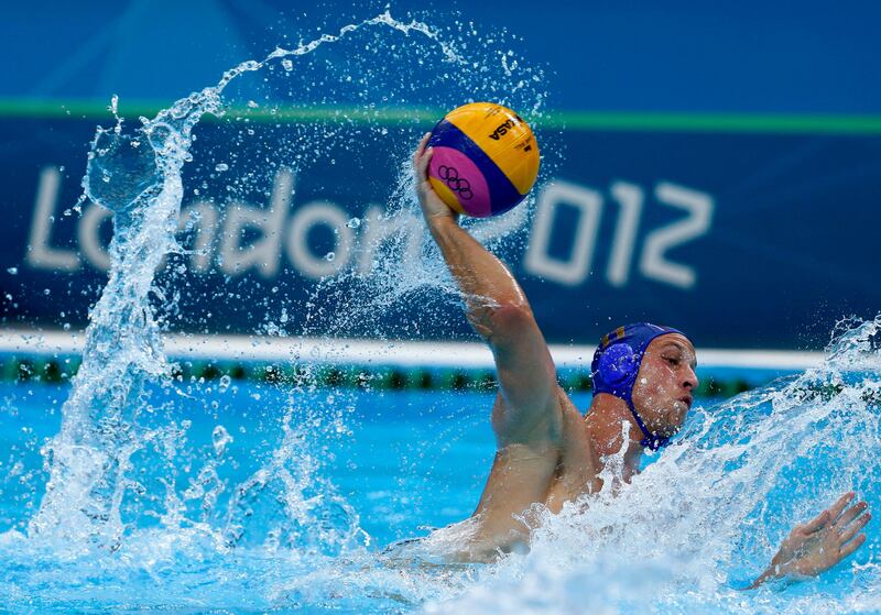 Andrija Prlainovic of Serbia shoots against Australia during a men's quarterfinal water polo match at the 2012 Summer Olympics, Wednesday, Aug. 8, 2012, in London. Serbia won 11-8. (AP Photo/Julio Cortez)