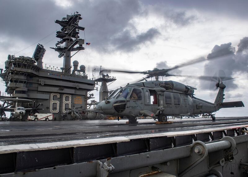 An MH-60S Sea Hawk helicopter conducts flight control checks on the flight deck of the US Navy aircraft carrier USS Nimitz in the Indian Ocean on November 25, 2020. Handout via REUTERS