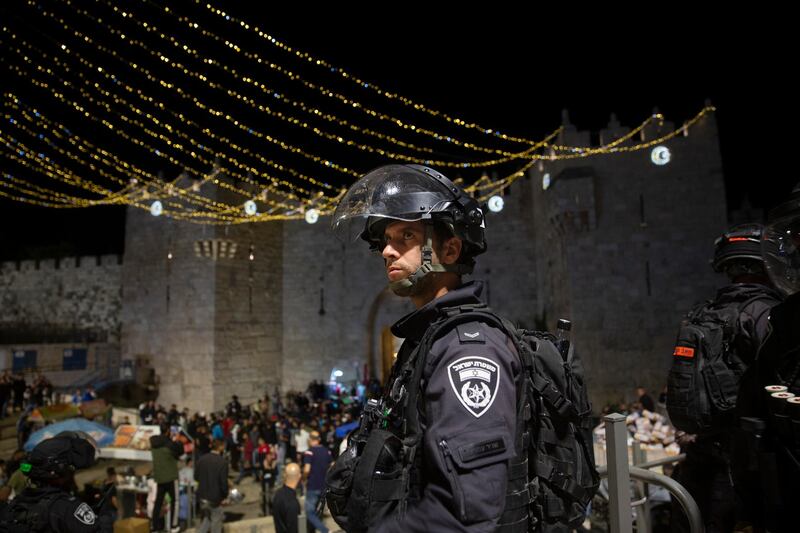 An Israeli police officer stands guard at the Damascus Gate to the Old City of Jerusalem after clashes near Al Aqsa Mosque on Friday, May 7, 2021. AP