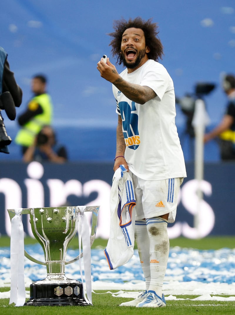 Real's Marcelo celebrates with the trophy. Reuters