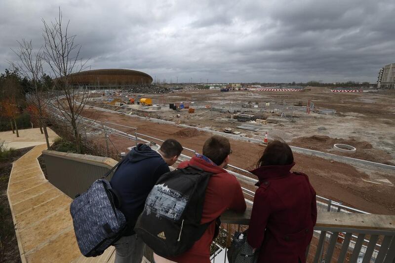 In this February 23, 2014 photo, people take a look at the construction site in Queen Elizabeth Olympic Park in east London. The Games’ Velodrome is seen left. London continues to bask in the success of the most recent Summer Games, but the Olympic legacy is difficult to determine. The flagship venue, renamed the Queen Elizabeth Olympic Park, is being converted into a massive park as big as London’s famous Hyde Park, complete with wildlife habitats, woods and sports facilities. The first part of the ambitious project will begin to open to the public in April. The 80,000-seat Olympic Stadium at the center of the park has been troubled by controversy since even before the games, and its post-games use was the subject of months of legal wrangling. The stadium is now being converted into a soccer venue and the home of the West Ham soccer club, with an expected price tag of $323 million. Many argue taxpayers should not have to fund a Premier League club, though officials insist that the stadium will continue to host other major sporting events, including the Rugby World Cup in 2015. Lefteris Pitarakis / AP Photo