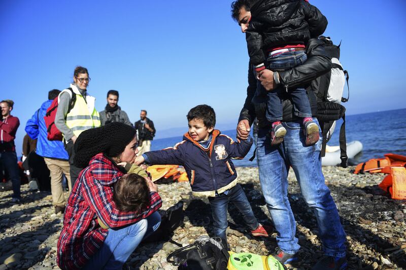 A Syrian family on the Greek island of Lesbos after crossing the Aegean Sea from Turkey with other refugees and migrants, on November 19, 2015. AFP
