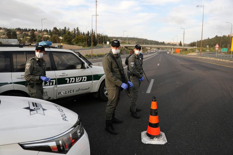 epa08348792 Israeli Police check car at a roadblock at the main road near the Israeli Arab village of Abu Ghosh leading to Jerusalem, Israel, 07 April 2020. Media reported that according to a government decision, Israeli police have enforced the lockdown on several cities and ultra-Orthodox Jewish neighborhoods across the country during the Jewish holiday of Passover in order to prevent the spread of the SARS-CoV-2 coronavirus which causes the Covid-19 disease.  EPA/ABIR SULTAN