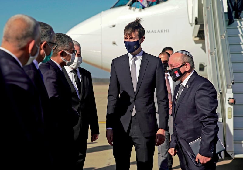 A handout picture released by the US Embassy in Morocco, shows US Presidential advisor Jared Kushner (C) and Israeli National Security Advisor Meir Ben Shabbat (R) greeting officials in Morocco's capital Rabat, upon landing of the first Israel-Morocco direct commercial flight, marking the latest US-brokered diplomatic normalisation deal between the Jewish state and an Arab country.  AFP