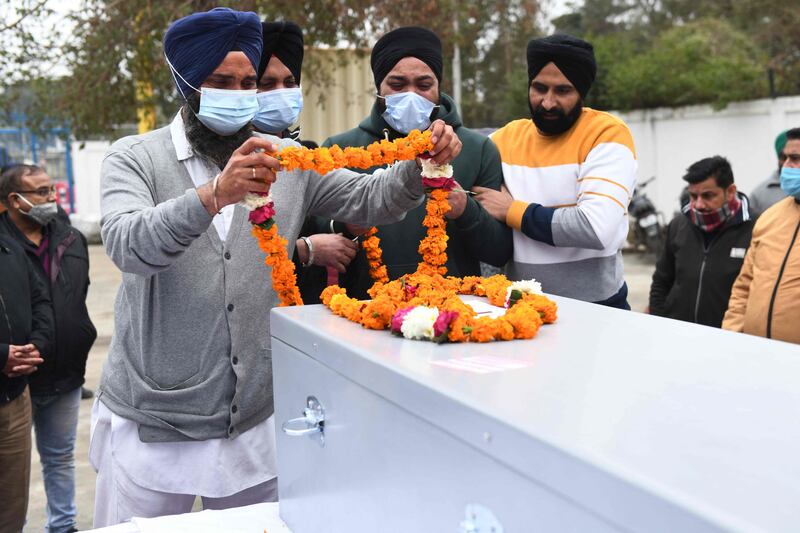 Relatives pay tribute in front of the coffin of Hardeep, a driver who was 29 years old.