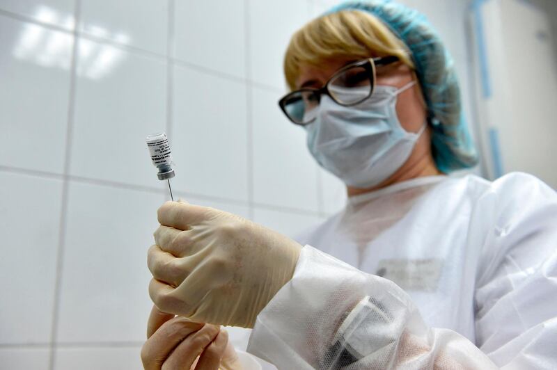 A nurse prepares to inoculate volunteer Ilya Dubrovin, 36, with Russia's new coronavirus vaccine in a post-registration trials at a clinic in Moscow on September 10, 2020. Russia announced last month that its vaccine, named "Sputnik V" after the Soviet-era satellite that was the first launched into space in 1957, had already received approval. The vaccine was developed by the Gamaleya research institute in Moscow in coordination with the Russian defence ministry. / AFP / Natalia KOLESNIKOVA                 
