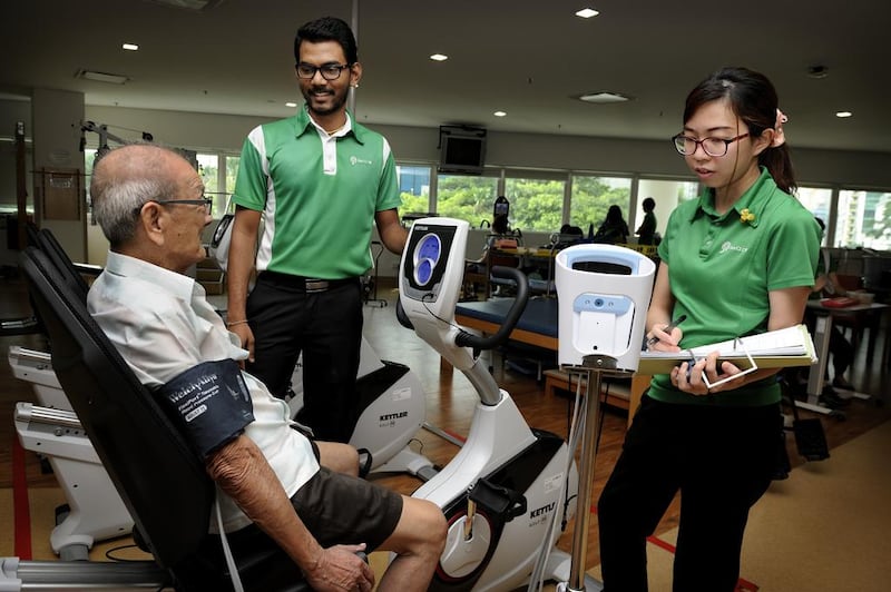 Staff nurses attend to an elderly patient doing rehab excercises at the Ren Ci Community Hospital in downtown Singapore. Munshi Ahmed for The National